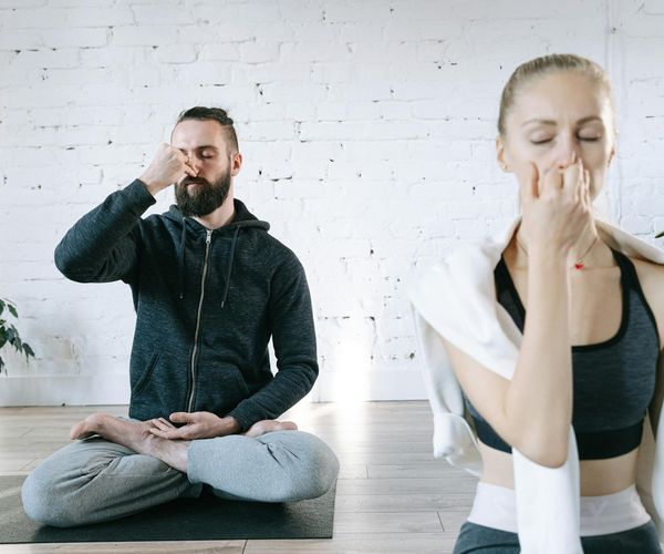 A cozy and calm corner of a room with a yoga mat, ready for practice.